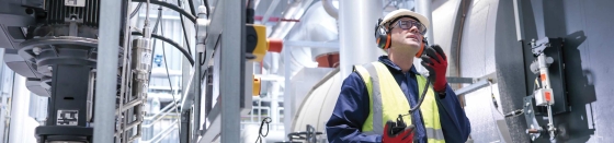 Worker using radio in gas fired power station