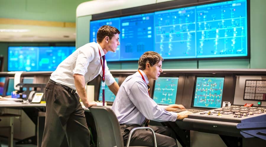 Operators in power station control room working with technical challenges, sustainability reporting.